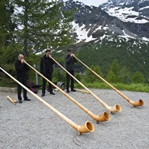 Men playing alpenhorn or alpine horn, Switzerland