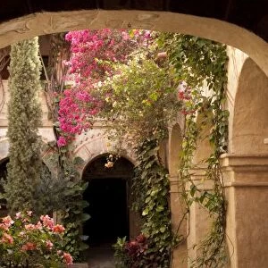 Mexico, Oaxaca Province, Oaxaca, courtyard of arches and bougainvillea flowers in Camino Real Hotel