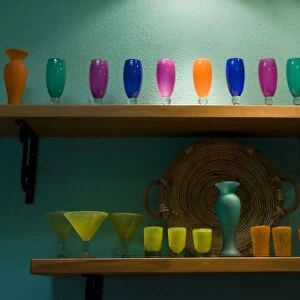 Mexico, San Miguel de Allende. Colorful collection of glassware on two shelves against