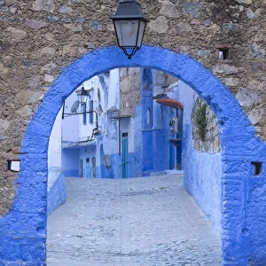 Morocco, Chefchaouen. A blue arch and quiet street entering the medina of the village