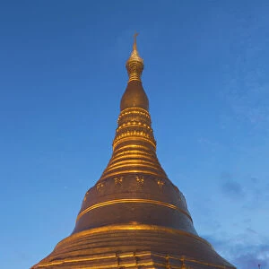 Myanmar, Yangon. A golden stupa at Shwedagon Pagodo, at twilight