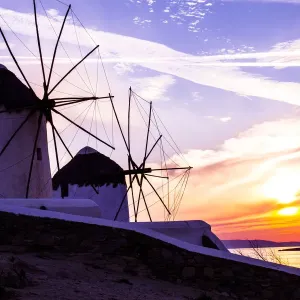 Mykonos, Greece. Two Windmills with a golden, pink, and blue sunset on the Aegean Sea Mykonos, Greece. Two Windmills with a golden, pink, and blue sunset on the Aegean Sea