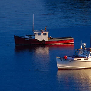NA, USA, Maine. Lobster boats out at sunset in Lubec