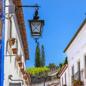 Narrow White Street 11th Century Castle Wall Medieval Town Lamp Obidos Portugal. Castle Narrow White Street 11th Century Castle Wall Medieval Town Lamp Obidos Portugal. Castle