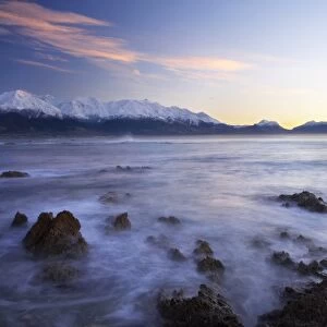 New Zealand, South Island, Kaikoura, Waves on Rocks and Seaward Kaikoura Range at Dawn