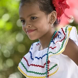 Nicaragua, Granada. Girl in traditional dress dancing in Villa Esperanza barrio. (MR)