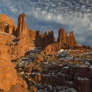 North America, USA, Utah. Fisher Towers with snow and clouds, near Castle Valley, Utah