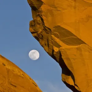 North America, USA, Utah. Looking through Skyline arch at full moon, Arches National Park