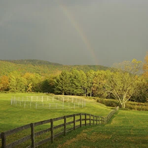 North America, USA, Vermont, Windsor County. Rainbow over a field in autumn