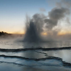 North America, USA, Wyoming, Yellowstone National Park. Eruption of Fountain Geyser after sunset