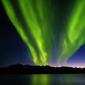 Northern Lights over Angmagssalik Fjord near settlement Kuummiit (formerly spelled Kummiut). Ammassalik area in East Greenland, Danish Territory Northern Lights over Angmagssalik Fjord near settlement Kuummiit (formerly spelled Kummiut). Ammassalik area in East Greenland, Danish Territory