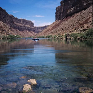 Oar powered rafts drift down the Colorado River deep inside the Grand Canyon
