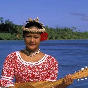 Oceania, French Polynesia, Tahiti. native woman playing music. MR