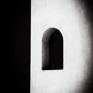 Oia, Greece. Santorini. Black and White Curved, Greek, White Washed, Stucco, Window Oia, Greece. Santorini. Black and White Curved, Greek, White Washed, Stucco, Window