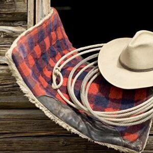 Oregon, Seneca, Ponderosa Ranch. Cowboy hat, rope and horse blanket sitting on the