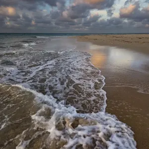 Pacific Islands, Kingdom of Tonga. Remote sandy beach on an uninhabitated island with incoming tide
