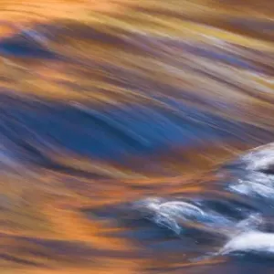 Painterly Impression of a rushing stream reflecting autumn colors Painterly Impression of a rushing stream reflecting autumn colors
