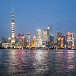 Pearl Tower over Pudong district skyline and Huangpu River Shanghai, China