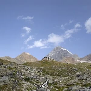Pizzini hut (2706 m) in the upper Sondrio province, Italy. In the background, the