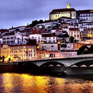 Portugal, Coimbra. Old Mondego River bridge and hillside view of Old University of Coimbra Portugal, Coimbra. Old Mondego River bridge and hillside view of Old University of Coimbra