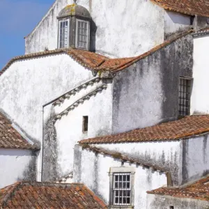 Portugal, Obidos. Ancient, red, terra cotta tiled roof tops, lines. Old windows Portugal, Obidos. Ancient, red, terra cotta tiled roof tops, lines. Old windows