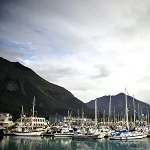 Private and Commercial Boats lie in Seward harbor amongst breaking skies