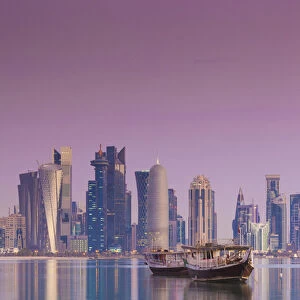 Qatar, Doha, Dhows on Doha Bay with West Bay skyscrapers, dawn