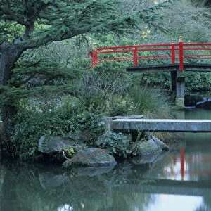 Red Japanese bridge and pond at Kubota Gardens, Renton, Washington