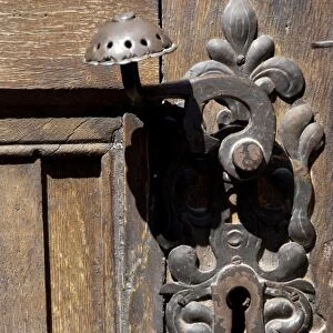 Romania, Transylvania, Brasov. The Black Church, detail of wooden door with iron latch