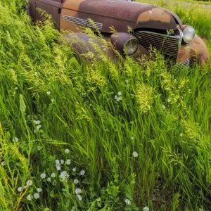 Rusty old vehicles in the ghost town of Okaton, South Dakota, USA