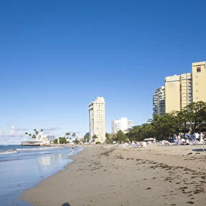 San Juan, Puerto Rico - People are relaxing in beach chairs on the beach of a resort hotel
