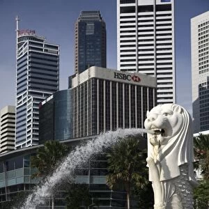 Singapore. Merlion statue in the Merlion Park with high rise office towers in Financial
