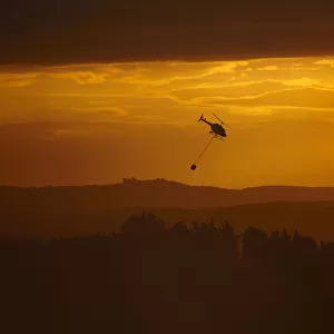 Smokey sunset and helicopter fighting fire at Burnside, Dunedin, South Island, New