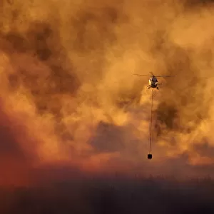 Smokey sunset and helicopter fighting fire at Burnside, Dunedin, South Island, New