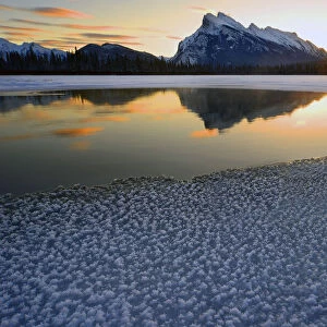 Snow crystals rim a lone break in the ice on Vermilion Lakes on a cold Banff National