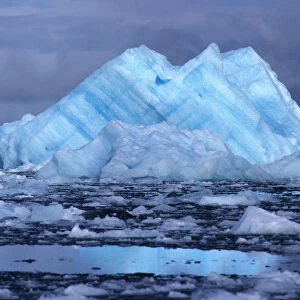 South America, Chile, San Rafael Lagoon NP. An iceberg, striated blue and white