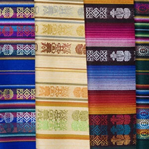 South America, Ecuador, Quito. Colorful shawls displayed at market