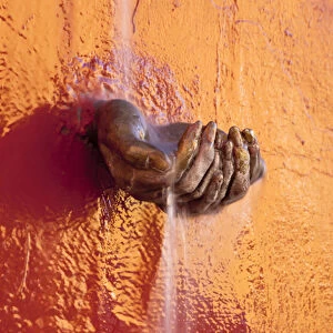 South America, Mexico, San Miguel de Allende. Fountain detail of water dropping in cupped hands