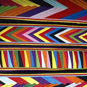 South America, Peru, Cinceros. Bold colors in fabric design in market. Credit as