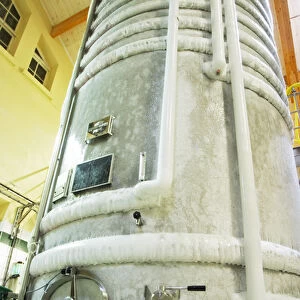 A stainless steel fermentation tank with still wine undergoing cold stabilization