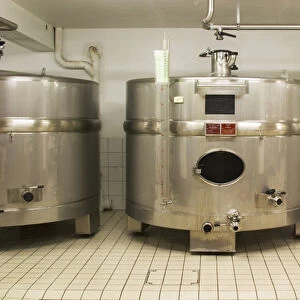 Stainless steel fermentation tanks of an unusual shape wider than they are high