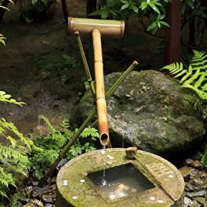 A stone water basin in the grounds of Ryoan-Ji Temple in Kyoto, Japan