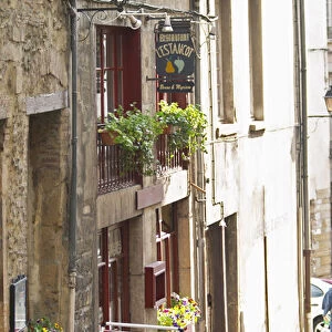 A street scene in Vinenne, a restaurant called lEstancot in the old town, with a sign