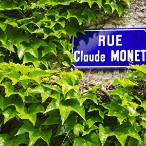 Street sign and ivy covered wall, Giverny, Normandy, France