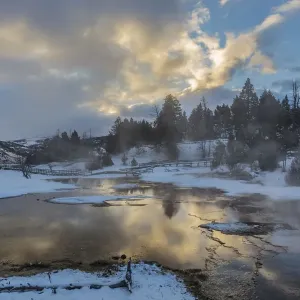 Sunrise clouds reflect into Grassy Spring in winter in Yellowstone National Park Sunrise clouds reflect into Grassy Spring in winter in Yellowstone National Park