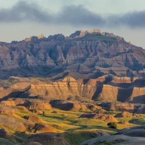 Sunrise light breaks through on a foggy morning in Badlands National Park, South Dakota