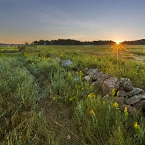 Sunrise over the salt marsh along the Essex River at the Cox Reservation in Essex