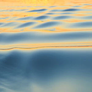 Sunset refecting on smooth surface, and small ripples, Moses Lake, WA, USA