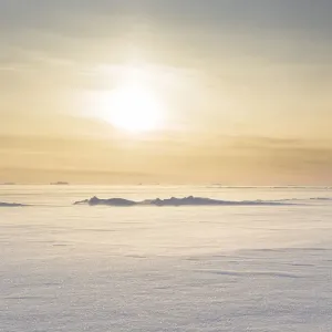 Sunset over the stormy and frozen Melville Bay, near Kullorsuaq in the far north of West Sunset over the stormy and frozen Melville Bay, near Kullorsuaq in the far north of West