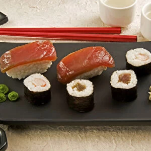 Sushi (Nigiri with salmon and Norimaki with rice, algae and fish), wasabi cream